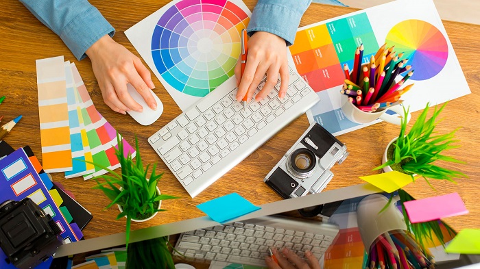 High Angle View Of An Artist Designing In Her Laptop At Her Office.