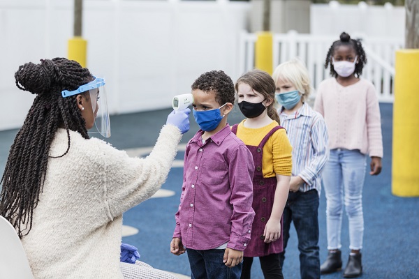 Children's temperatures being checked by the school nurse.