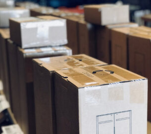 Things are packed in a cargo boxes that are ready to to be shipped.